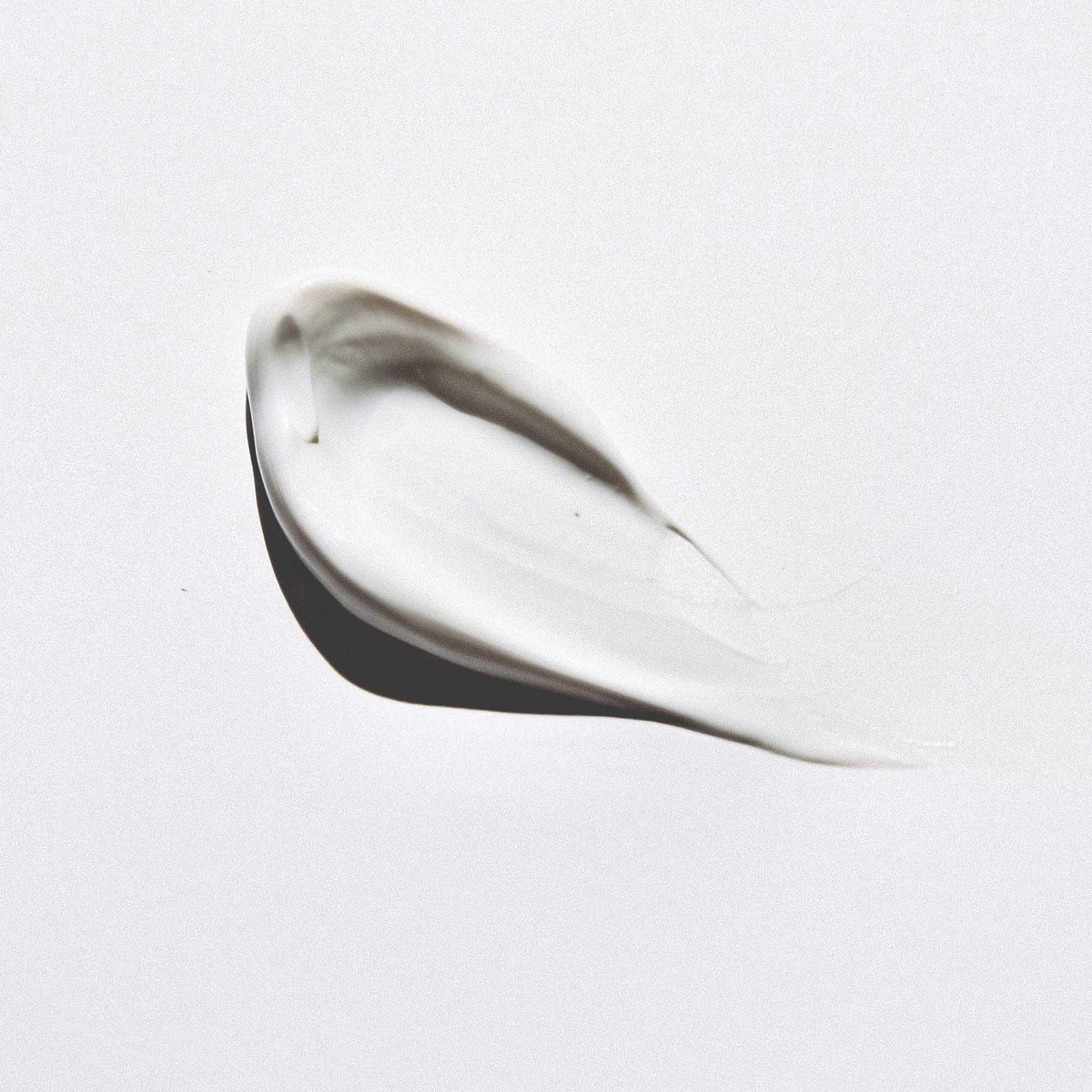 A smooth, ivory-colored swatch of Vino Glow on a white surface